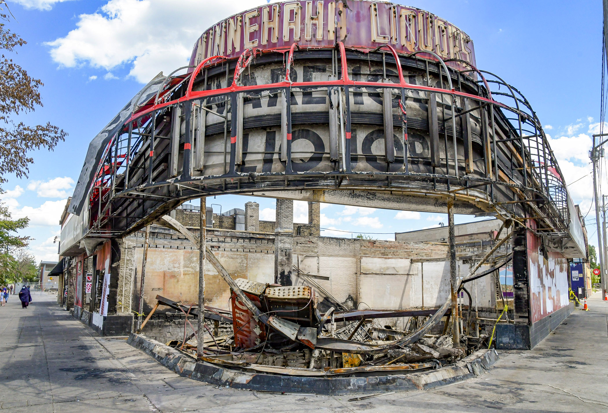 A burned-out liquor store stands at the corner of East Lake Street and Minnehaha Avenue in Minneapolis earlier this month. A bill heard Tuesday in the House would help businesses impacted by May's civil unrest to rebuild. Photo by Andrew VonBank